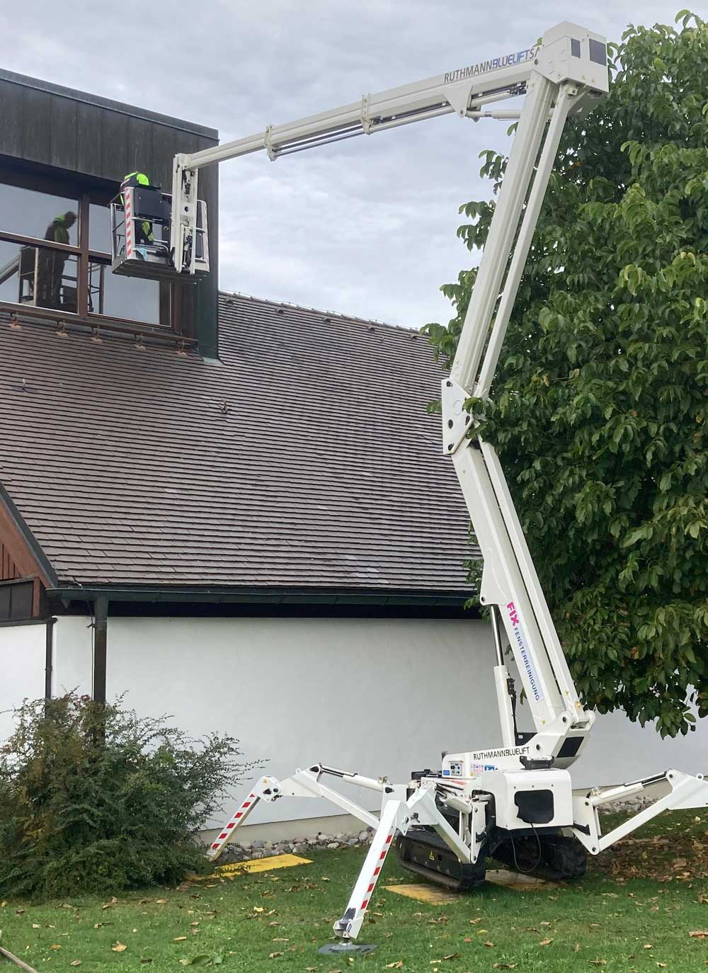 Raupenarbeitsbühne vor den hohen Giebelfenstern der Kirche in Eisenärzt